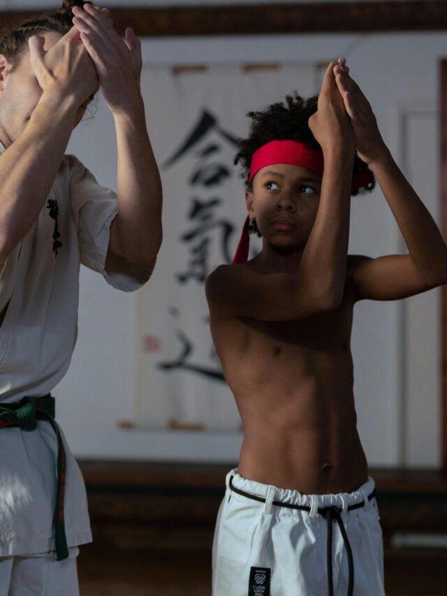 A Boy Training in the Gym with His Trainer